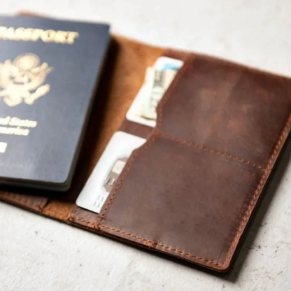 Brown leather wallet with passport and cards on a light surface